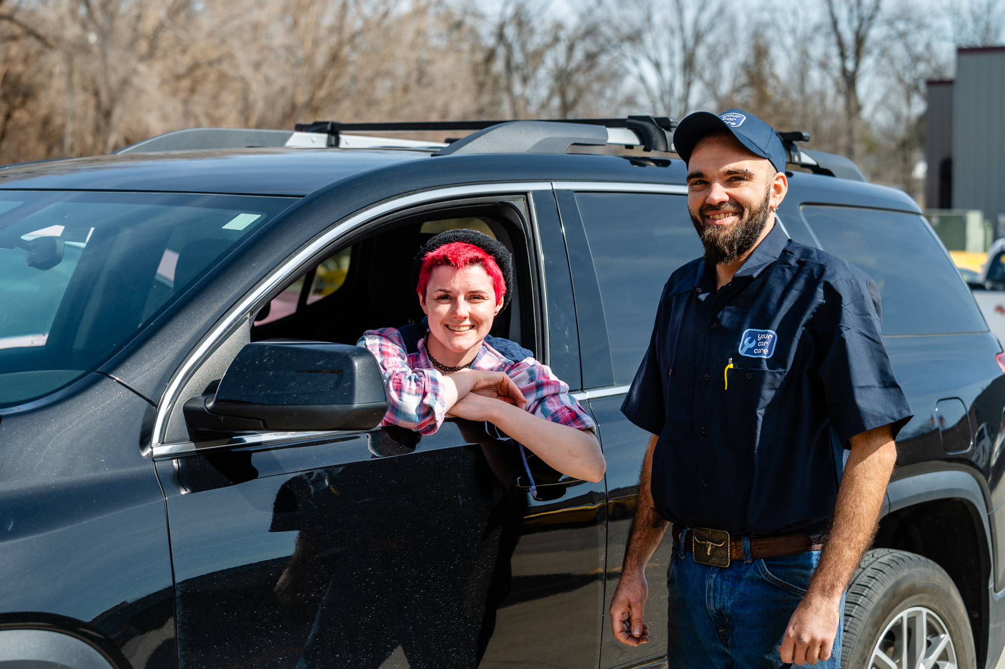 YCC technician posing with happy customer in her vehicle