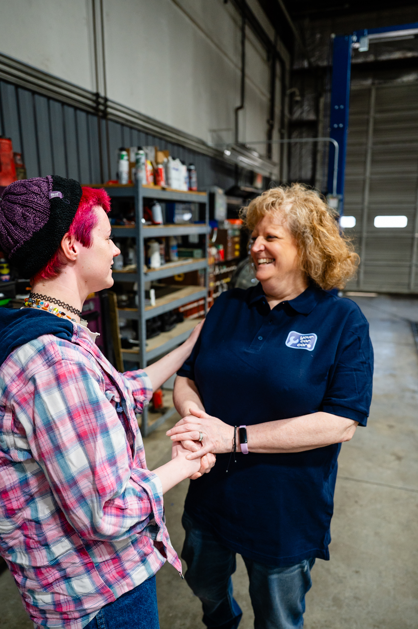 Auto technician chatting to a happy customer