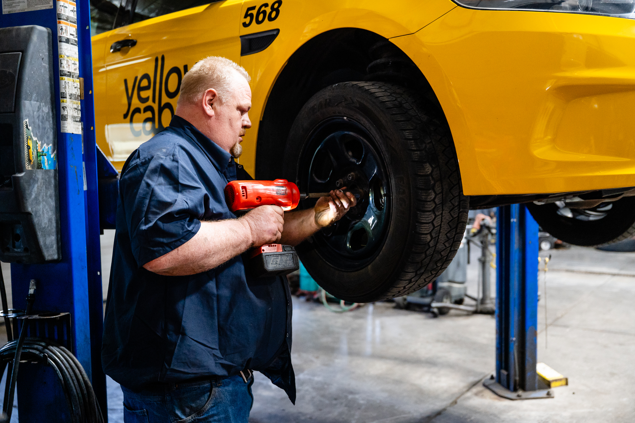 Technician completing tire service on a cab car